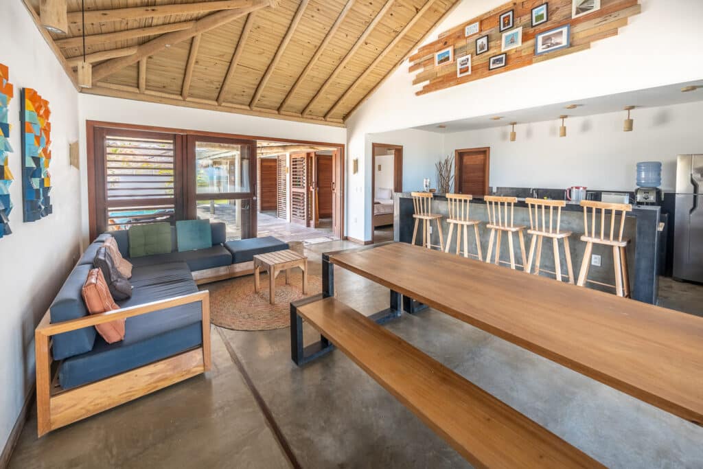 Salon avec canapé, table à manger et cuisine ouverte sous charpente bois, La Kite Family, Fortim
